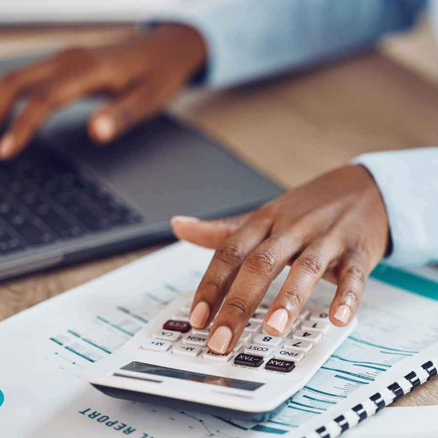 Accountant crunching numbers on a calculator.