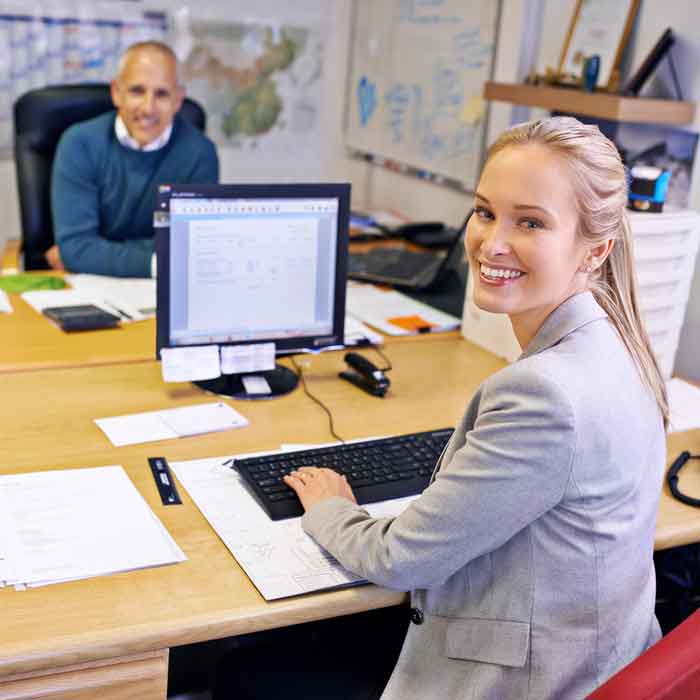 A temporary worker sitting at a desk after starting a temporary job.